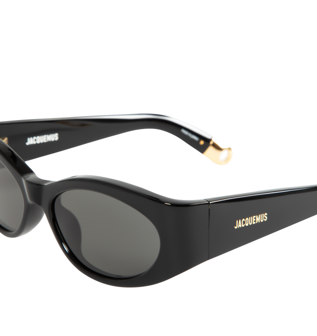 Image 3 of 3 - BLACK - Jacquemus X Linda Farrow Ovalo Sunglasses have gray lenses, gold temple detailing, and acetate frames. 100% UV-protected solid lenses. Made in Italy.  