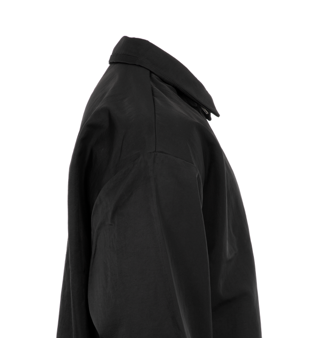 Image 3 of 3 - BLACK - Fear of God Textured Nylon Trucker Jacket has an attached hood, a snap button closure, dropped shoulders, elastic wrist cuffs, side seam pockets, a logo applique, and adjustable drawstring hem. Lined. 100% recycled nylon.   