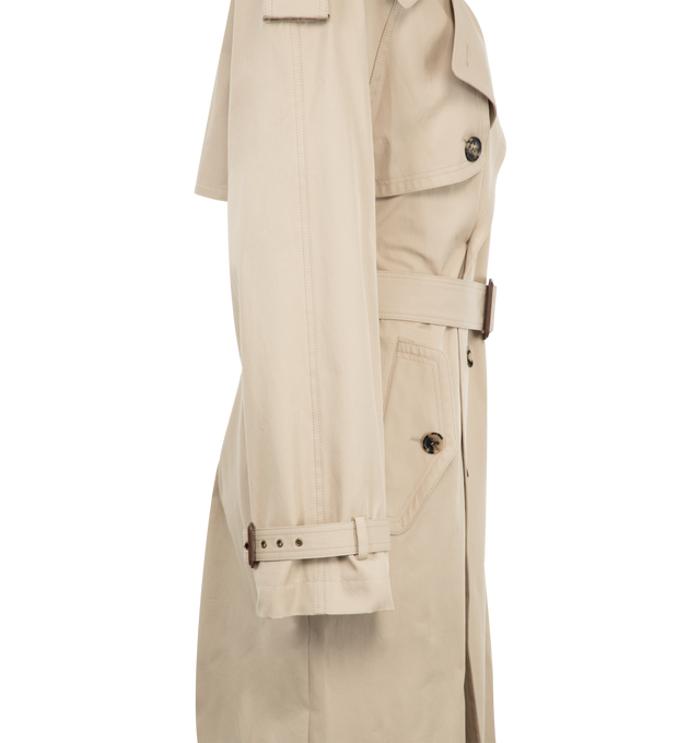 Image 3 of 3 - NEUTRAL - Saint Laurent Women's long double-breasted belted trench coat made with certified cotton twill. Featuring a two-way ulster collar, storm flap, buttoned epaulets, eight-button closure, two buttoned flap pockets at the front, one inner welt pocket, adjustable and detachable belt, single back vent and strapped cuffs, with silk lining.  100% COTTON. Made in Italy. 