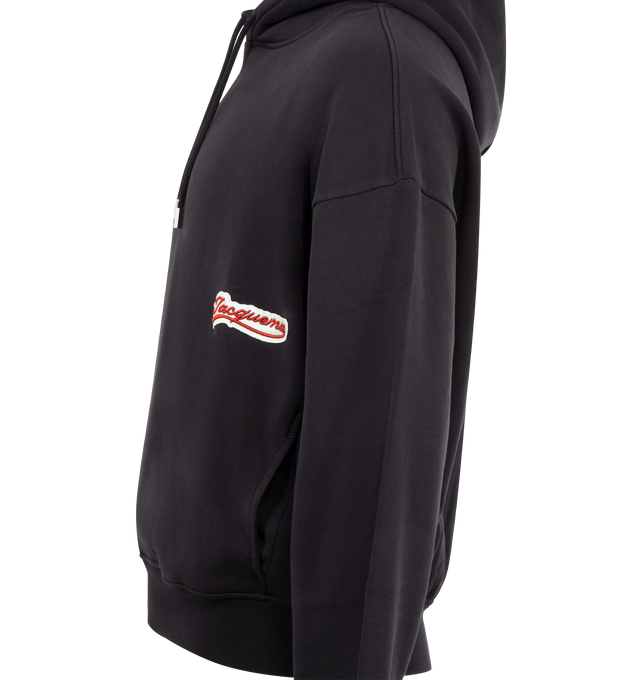 Image 4 of 4 - BLACK - JACQUEMUS Gio Hoodie featuring cotton hoodie with logo drawstring, logo embroidery on the front and back, side pockets and long cuffed sleeves. 100% cotton. Made in Portugal. 