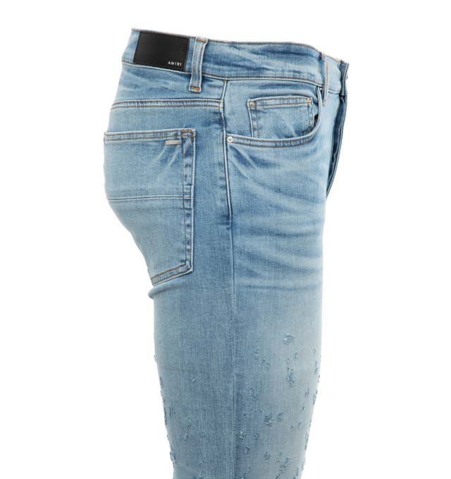 Image 2 of 2 - BLUE - AMIRI Shotgun Ripped Skinny Jeans featuring distressed and ripped detailing, contrast stitching, belt loops, classic five pockets, rivet detailing, whiskering effect and concealed fly and button fastening. 92% cotton, 6% elastomultiester, 2% elastane. 