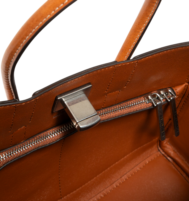 Image 3 of 3 - BROWN - BALENCIAGA Bel Air Carry All Bag Mini in cowboy vegetable tanned lambskin and aged-silver hardware featuring two handles with one handle clip, adjustable and removable strap, shoulder, crossbody and hand carry, Balenciaga Paris logo debossed with foil at back, removable cloche cls with two split rings, side snaps, turn lock closure, logo engraved on the closure system, wide front pocket, 1 main compartment, 2 inner zipped pockets and nappa lambskin bonded lining. Lambskin. Made in Ita 