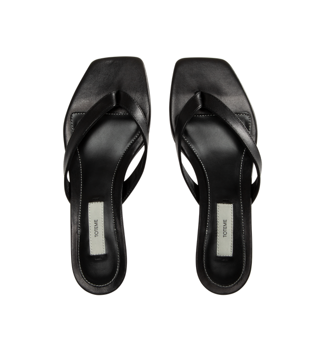 Image 4 of 4 - BLACK - Toteme Women's Leather Heeled Flip Flops are crafted in Italy from smooth, responsibly tanned leather and feature a minimalist thong silhouette with an open toe and easy slip-on construction. Set on a low 35mm heel, these designer sandals are finished with a leather lining and leather outsole, combining understated elegance with Toteme's signature minimalist aesthetic. Upper: Responsibly Tanned Leather. Lining: Leather. Outsole: Leather. Heel Height: 35 mm / 1.4 in. Made in Italy. 