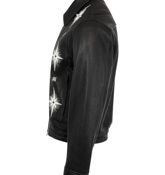 Image 3 of 3 - BLACK - Amiri Starburst Leather Bluson Jacket has a point collar, a 2-way zip closure, signature starburst appliques, snap cuffs, an elastic waist, and yoked back shoulders.  