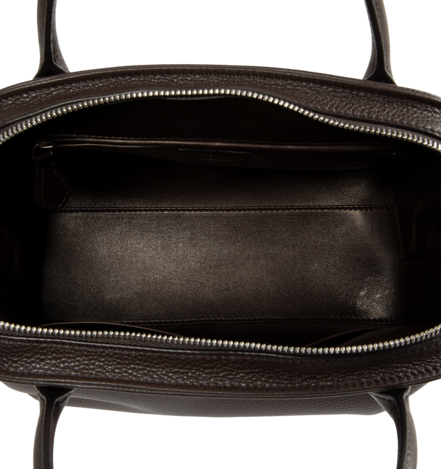 Image 3 of 4 - BROWN - The Row Agnes 12 Bag is crafted from finely grained calfskin leather and features a softly structured top-handle silhouette with tubular handles, gusseted side folds, a curved top zip closure, and a flat base. This designer leather handbag combines exceptional Italian craftsmanship with timeless minimalist design, offering a refined everyday carry with a spacious, elegant interior. Main Material: 100% Calfskin Leather. Lining: 100% Lambskin Leather. Dimensions: 12.99 x 5.91 x 8.27 in. 