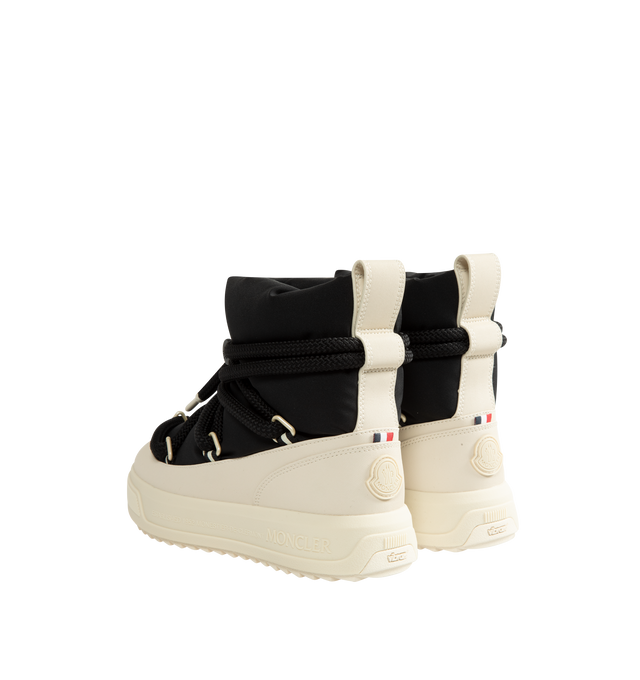 Image 3 of 4 - BLACK - Moncler Women's Altive Mid Snow Boots are designed with a boudin-quilted nylon upper and textured rubber overlays for lightweight protection and cold-weather performance. This mid-height silhouette features a wraparound drawstring fastening, pull tab at the backstay, and a round toe for comfortable everyday wear. Engineered with an EVA midsole and a Vibram MEGAGRIP tread for enhanced traction and durability, the style is finished with a lightweight TPU outsole for dependable grip in w 