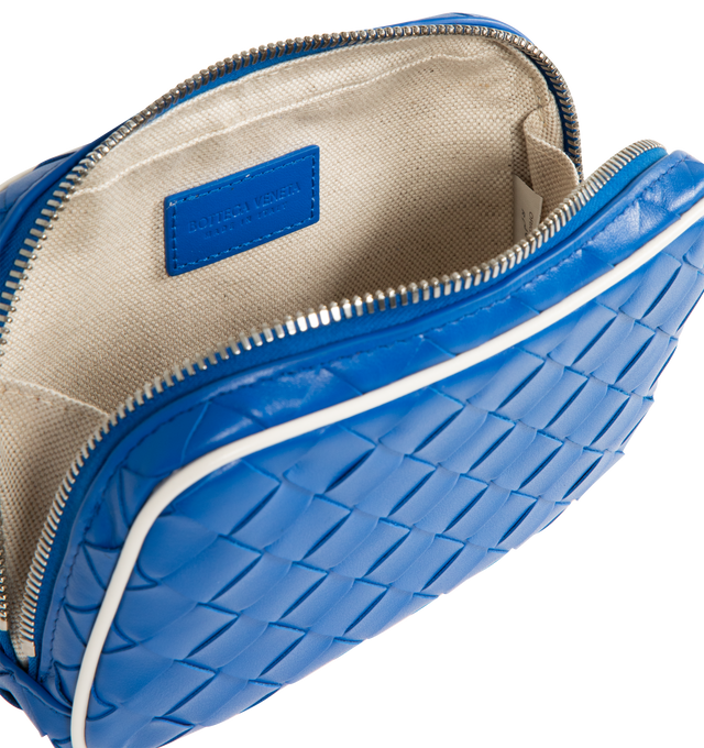 Image 4 of 4 - BLUE - Bottega Veneta small pouch in Intrecciato calf leather with contrasted piping, interior leather tag with embossed logo and zipper closure. Calfskin with canvas lining and silver finish hardware. Measures 5.1" high x 8.7" wide x 1.6" deep. Made in Italy. 