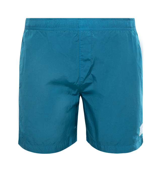 BLUE - C.P. COMPANY Eco-Chrome R Swim Shorts featuring tonal stitching, two side slash pockets, logo patch to the leg, short side slits, thigh-length, mesh lining and elasticated waistband with internal drawstring. 100% polyamide.