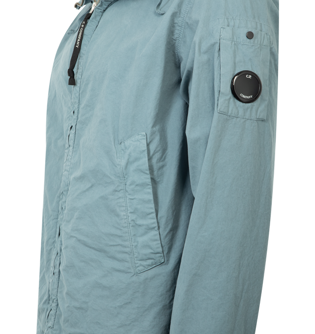 Image 3 of 3 - BLUE - CP COMPANY Microreps Hooded Jacket featuring zip fastening at front, regular fit, high-neck, drawstring hood, long sleeves, branded lens patch at sleeve, buttoned cuffs, two welt pockets at front and drawstring hem. 100% cotton. 