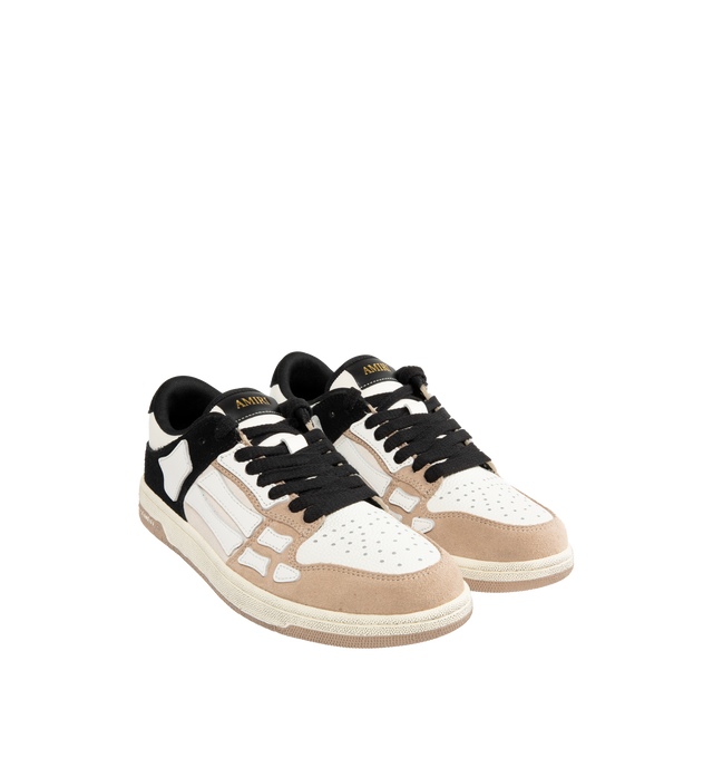 Image 2 of 5 - NEUTRAL - AMIRI Distressed Skel-Top Low Sneakers featuring appliqus throughout, perforated detailing at toe, lace-up closure, logo patch at padded tongue, padded collar, logo embossed at heel tab and treaded rubber sole. Upper: synthetic, leather. Sole: rubber.  