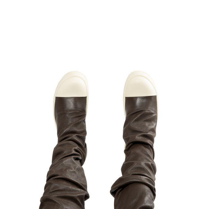 Image 5 of 5 - BROWN - Rick Owens Women's High Stocking Sneakers are crafted from stretch lamb leather and feature an above-the-knee silhouette, draped stocking-style uppers, toe caps, and the brand's signature shark-toothed bumper soles. Designed with a flexible stretch construction created by bonding leather to a cotton and Lycra backing, this statement style combines sculptural proportions with a secure, body-contouring fit. Main Material: 65% Lamb Leather, 34% Cotton, 1% Spandex. Toe: 100% Calf Leather. 