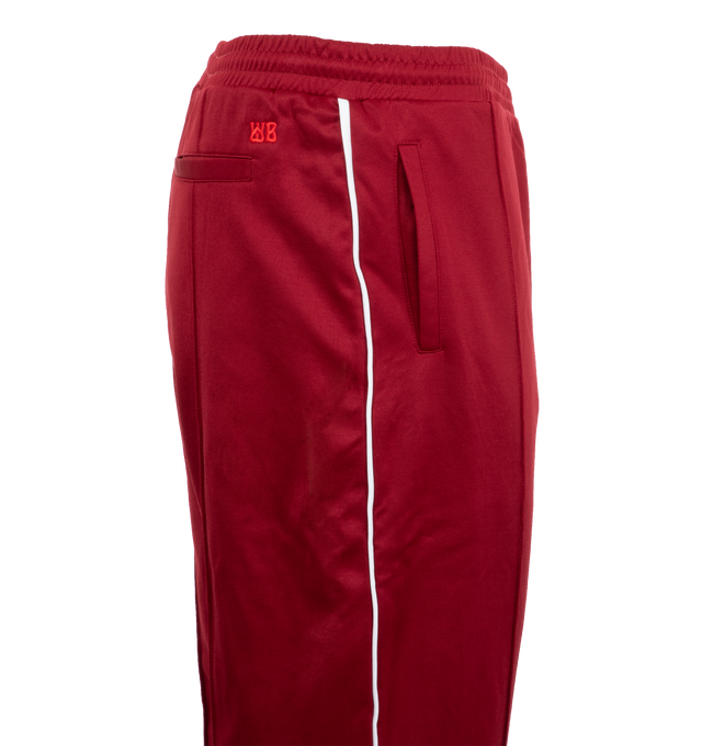 Image 3 of 3 - RED - Wales Bonner Men's Essence Track Pants are crafted with an elegant front pleat and contrast piping on the side-seam. An elasticated cuff and adjustable zip at the hem allow for versatile styling. Made in Portugal. 55% Polyester, 45% Cotton. 