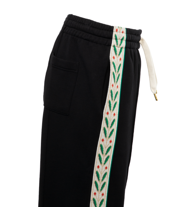 BLACK - CASABLANCA Laurel Tape Panelled Sweatpants featuring pull-on styling with elastic waistband and front drawstring tie closure, 3-pockets, contrast side tape at sides with signature artwork embroidery and midweight fleece fabric. 100% organic cotton.