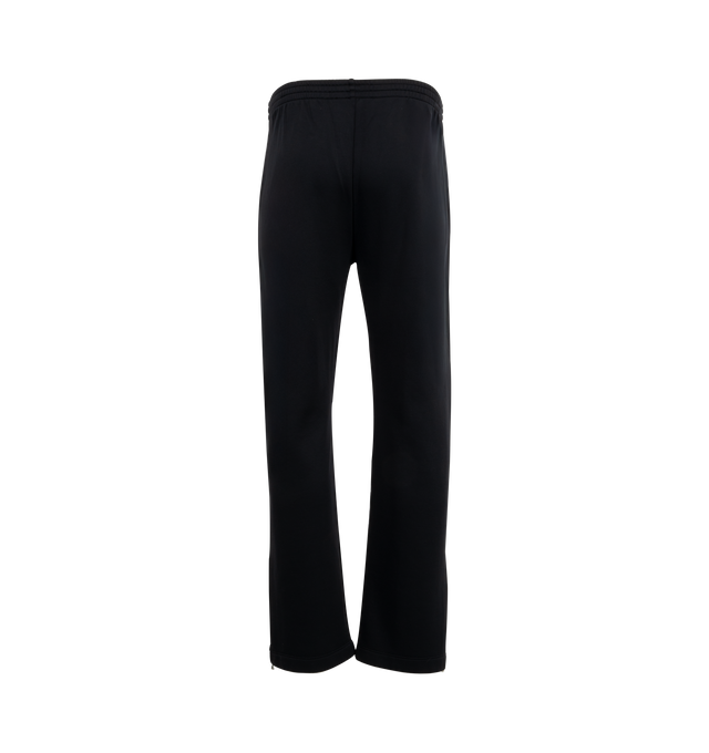 Image 2 of 3 - BLACK - OUR LEGACY Track Pants featuring soft fleece jersey, drawstring waist, two side pockets, stitched crease, vented side seam with zip closure and relaxed, wide legged fit. 55% polyamide, 45% cotton. 