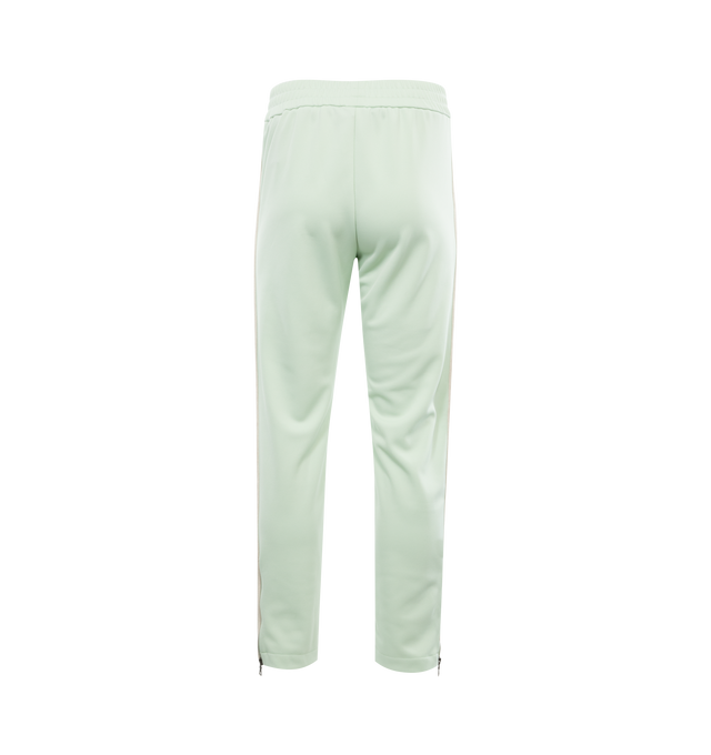 Image 2 of 3 - GREEN - PALM ANGELS CLASSIC LOGO TRACK PANTS with elastic waistband, ecru side bands and vertical pockets, ankle zippers and white embroidered logo at the front thigh. 100% polyester.  