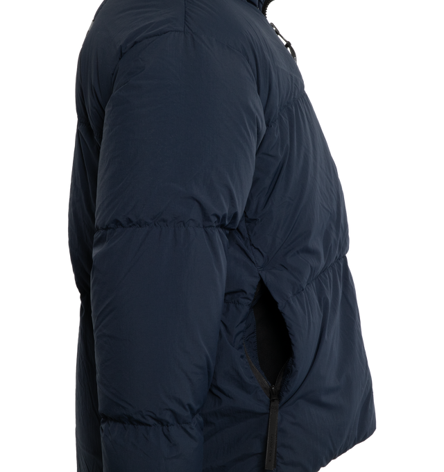 Image 3 of 3 - NAVY - CANADA GOOSE Lawrence Water Repellent 750 Fill Power Down Puffer Jacket featuring two-way front-zip closure, stand collar, inset ribbed cuffs, hidden side-zip pockets, interior zip pocket, interior mesh drop-in pockets, interior shoulder straps for hands-free carry, reflective details enhance visibility in low light or at night, water-repellent and lined with 750-fill-power down fill. 100% recycled nylon. Made in Canada. 