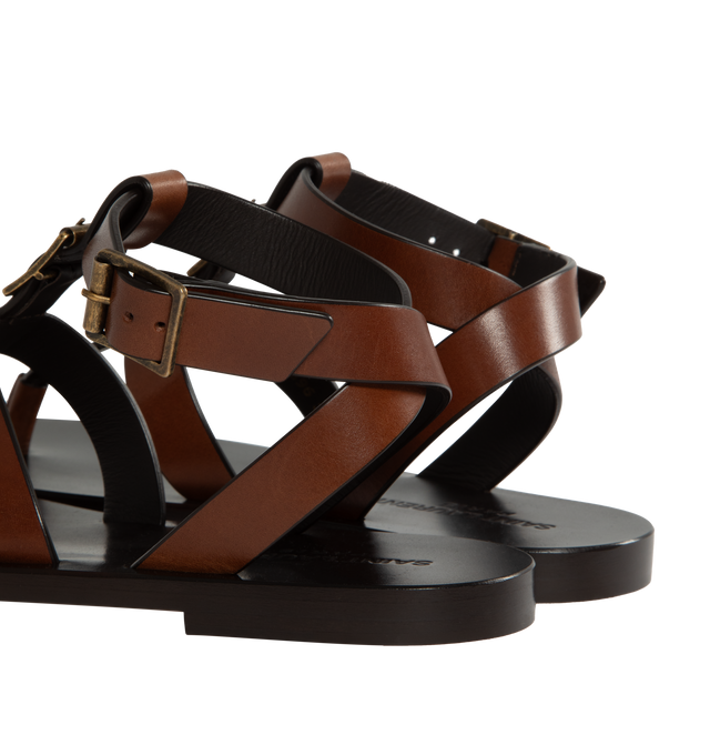 Image 3 of 4 - BROWN - Saint Laurent leather sandals featuring 5 mm flat heel, thong strap with buckle accent, adjustable ankle strap with a leather outsole. Made in Italy. 