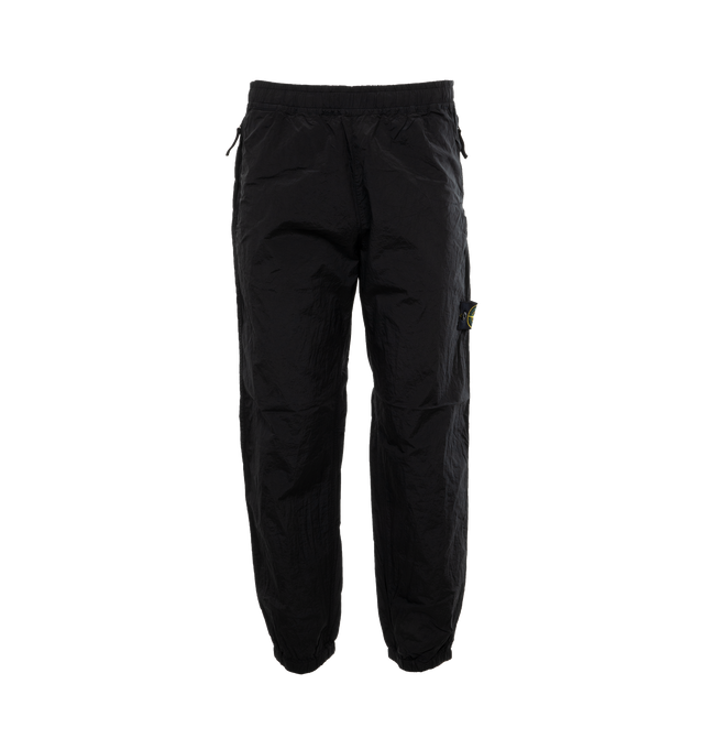 BLACK - STONE ISLAND Regular Fit Sweatpants featuring valet stand hand pockets with zipper closure inner tape edging, one patch pocket on back with horizontal zipper closure topped with nylon tape, Stone Island badge on the left leg, elasticized leg bottom and elasticized waistband with inner drawstring. 100% polyamide/nylon.
