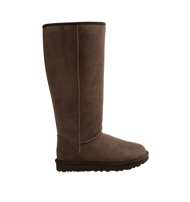 Image 1 of 4 - BROWN - Ugg Women's Classic Ultra Tall Boot is a sky-high version of the iconic style. Featuring a 15-inch shaft height, plush sheepskin lining, and an ultra-lightweight rubber outsole for comfort. Main Material: 17mm Twinface Sheepskin. Lining: 17mm Sheepskin. Insole: 17mm Sheepskin. Sole: Sugarcane EVA. Details: Overlock Stitch Seams.  
