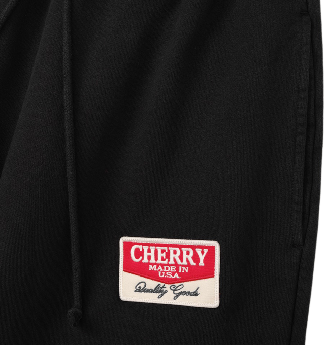 Image 3 of 6 - BLACK - Cherry LA Chevron Parachute Sweatpants are crafted from custom cotton fleece and feature a wide-leg silhouette with a relaxed, laid-back fit. Designed with a patch detail at the leg, an adjustable drawcord waistband, and a branded label at the back pocket, these everyday sweatpants blend comfort-focused construction with Cherry LA's signature contemporary aesthetic. Main Material: Custom Cotton Fleece. Made in Los Angeles, USA. 