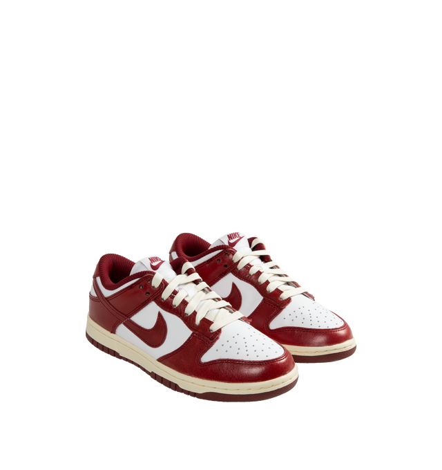 Image 2 of 5 - WHITE - Nike Women's Dunk Low Premium Sneakers have leather uppers, removable insoles, textile linings, and rubber soles.  