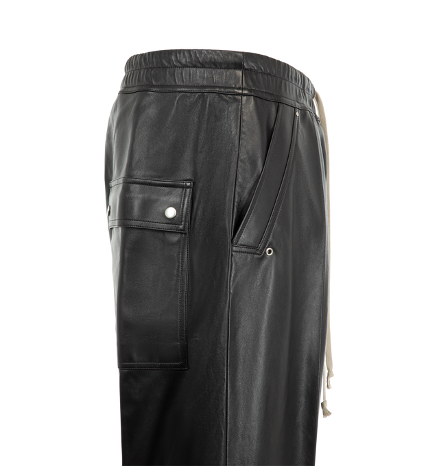 Image 3 of 3 - BLACK - Rick Owens Men's Bela Pants are crafted from lightweight waxed lamb leather and feature a loose-fit, full-length silhouette with a dropped crotch. Designed with an elasticized drawstring waistband, exposed zip Bela fly, side welt pockets, and back flap pockets with snap closures. Main Material: 100% lamb leather. Lining: 100% cupro.  