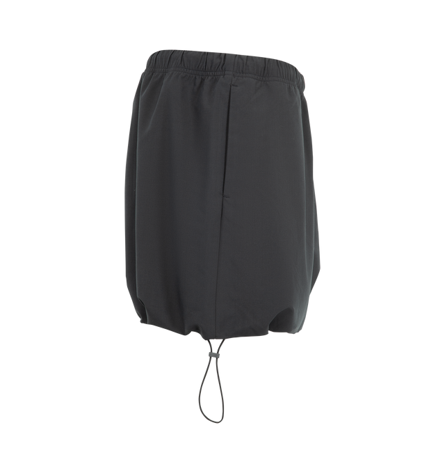 Image 3 of 3 - BLACK - The Fear Of God Essentials Women's Micro Skirt is crafted from a silk stretch blend for elevated comfort. This mini silhouette features an encased elastic waistband with bungee drawcords and adjustable toggles at the waist and hem. Materials: 69% Polyester, 19% Silk, 8% Wool, 4% Spandex. 