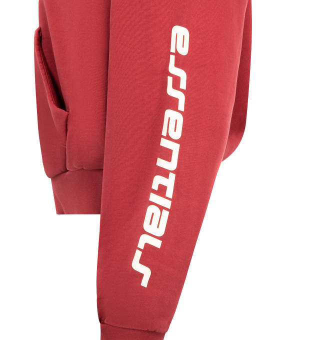 Image 3 of 3 - RED - FEAR OF GOD ESSENTIALS Classic Hoodie featuring front kangaroo pocket, cotton fleece fabric. cropped fit and logo on front and sleeve. 100% cotton. 
