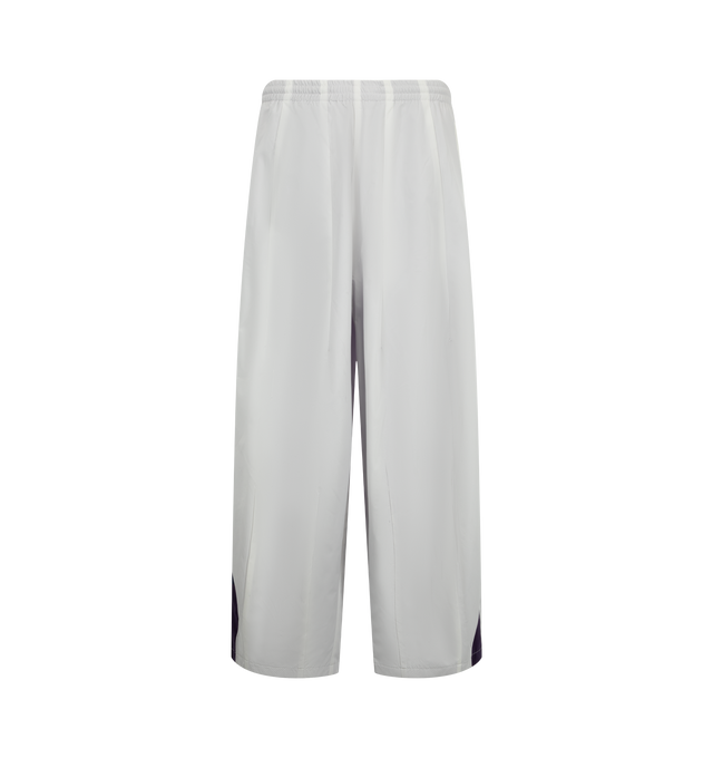 Image 1 of 3 - GREY - Needles x Fila Men's H.D. Wind Pant is crafted from lightweight technical fabric and features the signature H.D. silhouette with a voluminous, curved leg shape. Created in collaboration with Fila, this relaxed-fitting style combines sportswear functionality with Needles' distinctive proportions for a modern interpretation of a classic wind pant. Main Material: Technical Fabric. Fit: Relaxed. Silhouette: H.D. Wide Leg. Collaboration: Needles x Fila. Made in Japan. 