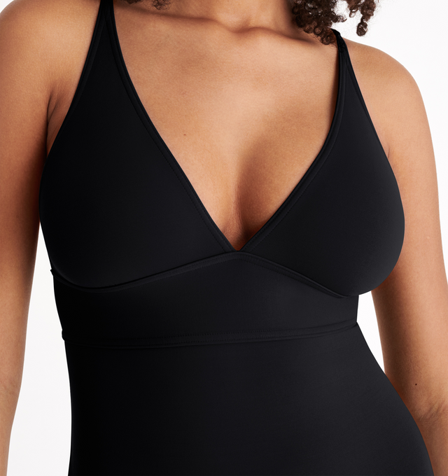 Image 6 of 6 - BLACK - ERES Larcin One-Piece Triangle Swimsuit featuring thin straps, V-neckline and underbust seam. 84% Polyamid, 16% Spandex. Made in France. 