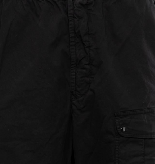 Image 4 of 4 - BLACK - STONE ISLAND Loose-Fit Cargo Pants featuring slanting hand pockets with slanted shaped flap and snap fastening, one patch bellows pocket on the back with shaped flap fixed on one side with a snap on the other side, big patch bellows pocket on the left leg, fixed on one side, snap on the other side, Stone Island badge, elasticized leg bottom and elasticized waistband with inner drawstring. 97% cotton, 3% elastane/spandex. 