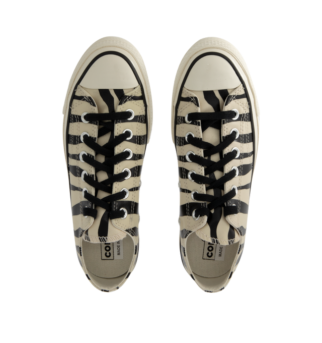 Image 5 of 5 - MULTI - Converse retro animal print Chuck 70 low top lace-up sneaker glows in the dark. Featuring timeless canvas upper, OrthoLite cushioning providing optimal comfort, black flat lace ties, Iconic Chuck Taylor patch. Unisex style in men's sizes. This style runs large- order 1/2 size down. 