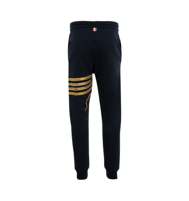 Image 2 of 3 - NAVY - Thom Browne Lunar New Year Sweatpants With Gold 4 Bar embroidered snakes made from breathable cotton fabric in a pull-on style featuring drawstring waistband with gold tone aglets, side slip pockets, name tag applique. 100% Cotton. Made in Italy. 