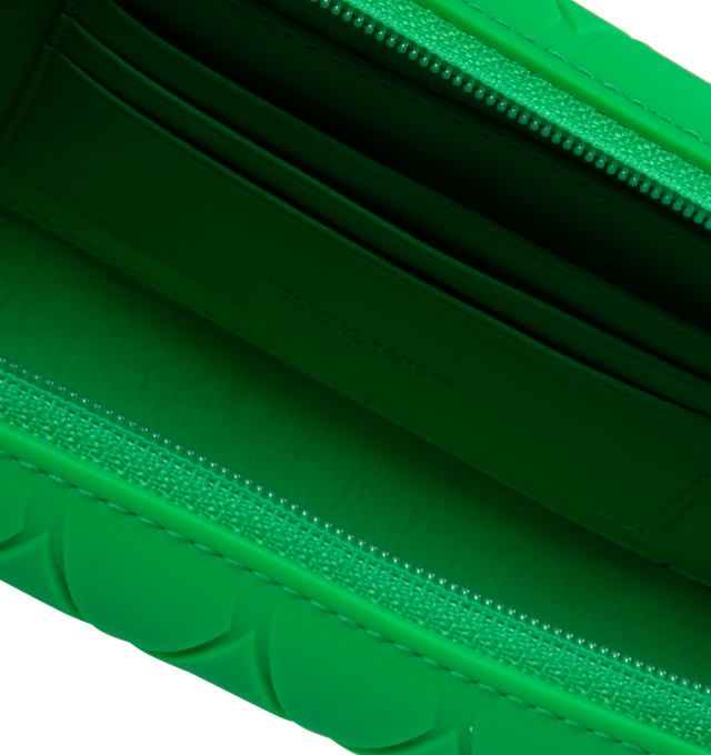 Image 3 of 3 - GREEN - BOTTEGA VENETA Tech Rubber Clutch featuring intreccio rubber silicone clutch with detachable and adjustable leather strap, three interior card slots and zippered closure. 7.3" x 4.3" x 2". Strap drop: 18.9". 100% calfskin. Made in Italy. 
