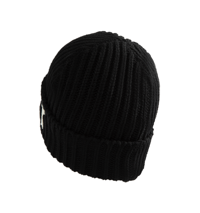 Image 2 of 2 - BLACK - SAINT Mxxxxxx Knit Cap / Saint Beanie is crafted from a wool and acrylic blend and features a rib-knit construction with a rounded crown silhouette. Designed for everyday cold-weather wear, this essential accessory is finished with a logo graphic print that reflects the brand's signature aesthetic. Main Material: 50% Wool, 50% Acrylic.  