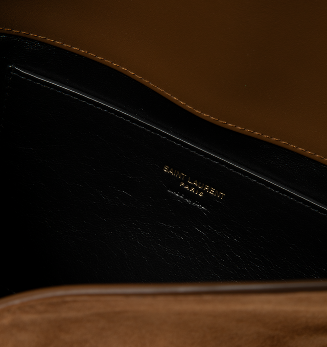 Image 3 of 3 - BROWN - Saint Laurent Women's Cassandre YSL Pouch On Chain Bag is crafted from rich calfskin suede and adorned with the house's iconic Cassandre logo accent in gold-tone hardware. Designed with a structured envelope silhouette, this versatile style features a stowable leather-and-chain shoulder strap that allows it to be carried as a shoulder bag or clutch. The design is finished with an envelope flap and magnetic closure, a cotton-lined interior, and a slip pocket for streamlined organizatio 