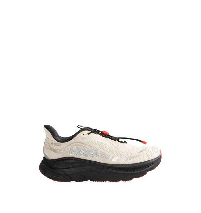 Image 1 of 5 - NEUTRAL - Hoka Men's Clifton 11 GTX Running Sneakers feature a closed-mesh upper with a GORE-TEX Invisible Fit membrane and PFC-free water-repellent treatment. An adjustable speed-lace system with toggle, reflective details, a compression-molded EVA midsole, and a Durabrasion rubber outsole with forefoot traction pods complete the weather-ready design. Upper: Mesh with GORE-TEX Membrane. Midsole: EVA Foam. Sole: Rubber. Heel-to-Toe Drop: 8 mm. 