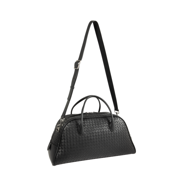 Image 2 of 3 - BLACK - Bottega Veneta Men's Bauletto Bag is crafted from Intrecciato leather and features an adjustable and detachable crossbody strap, a zip-top closure, and a suede-lined interior. Designed for everyday organization, it includes one interior zip pocket and two flat open pockets, and is finished with silver-tone hardware. Main Material: Calfskin Leather. Lining: Suede. Hardware: Silver Finish. Made in Italy. *This item may be restricted for online purchase to international clients. For assi 