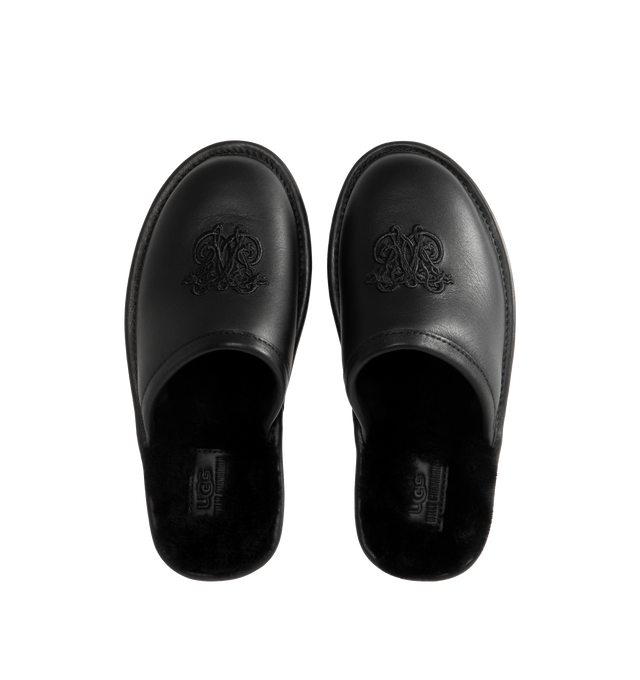 Image 4 of 4 - BLACK - UGG x Willy Chavarria Leather Hotel Slippers are crafted from black leather and feature a luxury reinterpretation of the classic hotel slipper silhouette. Designed with Chavarria's crest embroidered, and lined with UGG's signature plush sheepskin for exceptional comfort. Main Material: Leather. Lining: Sheepskin. Unisex style in men's sizes. 