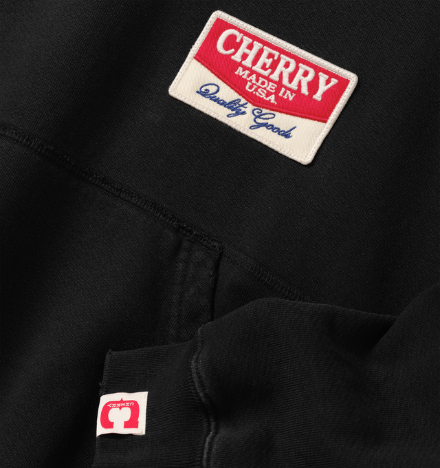 Image 3 of 6 - BLACK - Cherry LA Chevron Pullover Hoodie is crafted from custom cotton fleece and features a boxy-fit silhouette with a classic pullover design. Designed with a chest patch, distressed detailing, and a branded label at the cuff, this everyday essential combines a relaxed fit with Cherry LA's signature worn-in aesthetic. Main Material: Custom Cotton Fleece. Made in Los Angeles, California. 