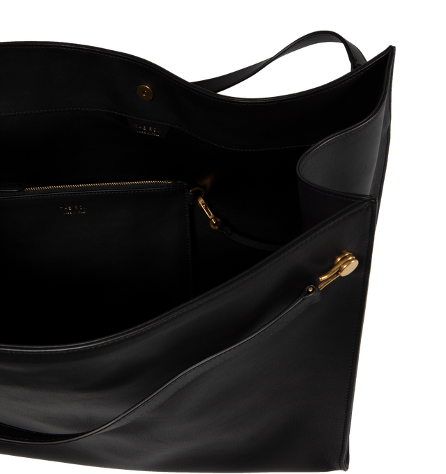 Image 3 of 3 - BLACK - THE ROW soft, deconstructed tote in polished saddle leather with interior tie closure, interior zip pocket, flat handles, and architectural draping to create volume. Measures 17 x 11.5 x 6 in. 100% Calfskin Leather lined in 100% Leather. Made in Italy. 