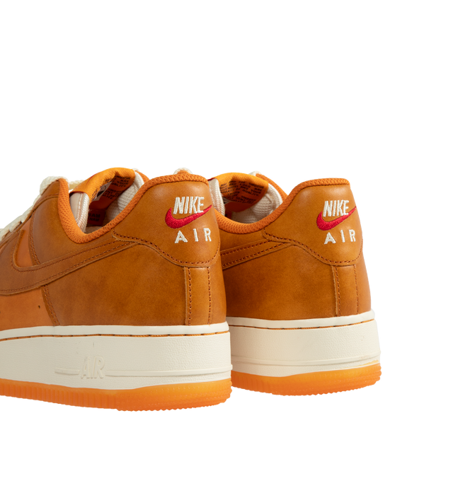 Image 3 of 5 - ORANGE - Nike Air Force 1 '07 LV8 Sneakers are a lace-up style with perforations for ventilation, foam soles, encapsulated Air cushioning, and padded collars.  