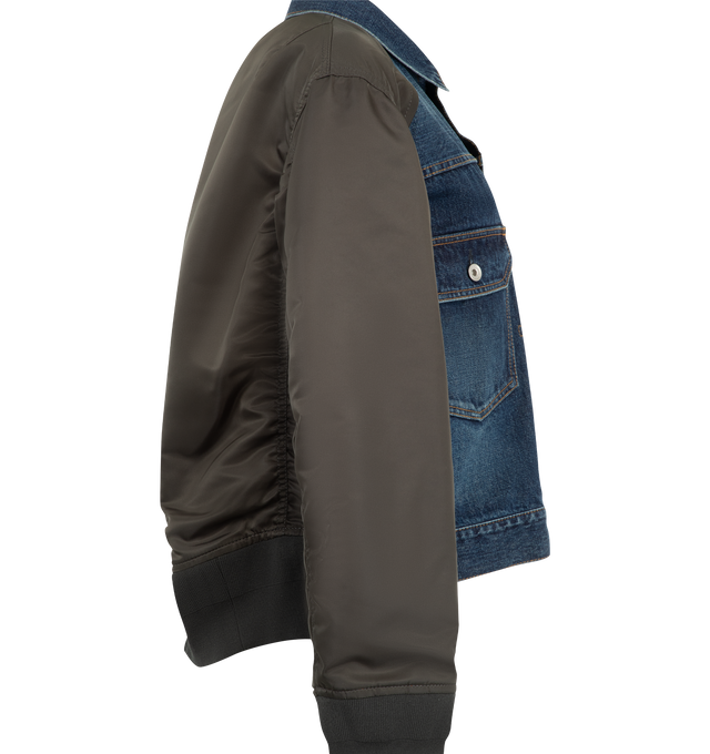 Image 3 of 4 - BLUE - Sacai denim bomber blouson with cotton denim front panel and contrast nylon twill sleeves. Features a classic collar, button-front closure, contrast stitching, patch pockets with flap and button, zip pocket on the sleeve, ribbed hem and cuffs, and back central crease. Outer is 100% cotton denim with 100% nylon sleeves and 100% polyester lining. Made in Japan. 