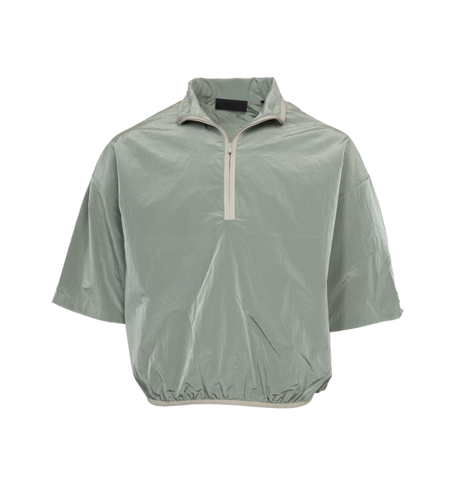 GREEN - FEAR OF GOD ESSENTIALS Halfzip Mockneck Shirt featuring relaxed fit, stretch binding mock neckline and waist hem, logo on cuff and rubberized label at back collar. 100% nylon. 