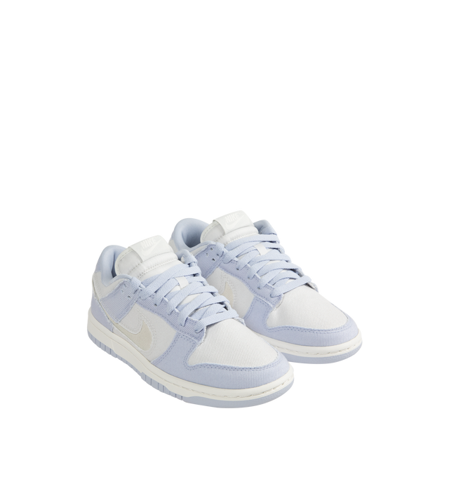 Image 2 of 5 - WHITE - Nike Dunk Low Sneakers are a lace-up style with foam midsoles, cutout Swoosh logos, padded collars, and rubber outsoles.  