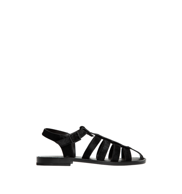 BLACK - THE ROW Pablo Sandal in Pony featuring artisanally-crafted fisherman sandal in smooth pony hair leather with woven leather straps, closed rounded toe, tinted buckle closure, and flexible leather sole. 100% leather. Made in Italy.