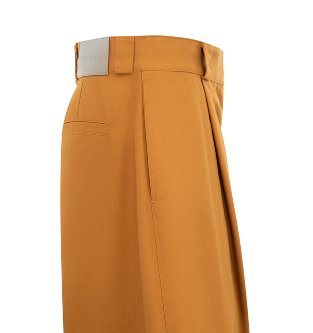 Image 3 of 3 - BROWN - BALENCIAGA Pleated Barrel-Leg Ankle Bermuda Pants featuring curved barrel silhouette with a single pleated front, mid rise sits high on hip, single pleated front, two front slash pockets, two back welt pockets, leather jacron with Balenciaga logo at the back, curved barrel legs, cropped at the ankle, covered snap button, zip fly and belt loops. Cotton/leather. Made in Italy. 