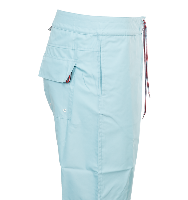 Image 3 of 3 - BLUE - THOM BROWNE Board Shorts have a drawstring waist, 4 bar detail on the left thigh, single flap back pocket, slant side pockets, and name tag above the left cuff. 94% polyamide, 6% polyurethane. Lining: 100% polyester. Made in Itlay.  