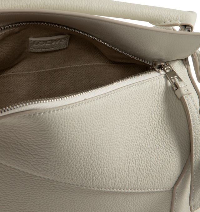 Image 3 of 3 - WHITE - LOEWE Small Puzzle Bag has a zipper closure, removable and adjustable shoulder strap, exterior zip pocket, interior slip pocket, and embossed signature Anagram. Lined. Measures 6.5 inch high X  9.4 inch wide X 4.1 inch deep. 100% calf leather. Made in Spain.  