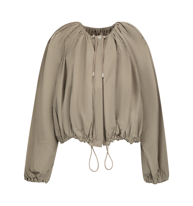 Image 1 of 2 - NEUTRAL - Toteme Women's Gathered Parachute Coat is crafted from a lightweight polyester blend and features a relaxed parachute-inspired silhouette with adjustable drawstrings at the neckline and hem for customizable volume. Designed with a zip-and-snap front closure and side pockets, this designer coat combines functional utility with Toteme's signature minimalist aesthetic, creating a versatile outerwear layer for everyday wear. Main Material:97% Polyester, 3% Polyamide. 